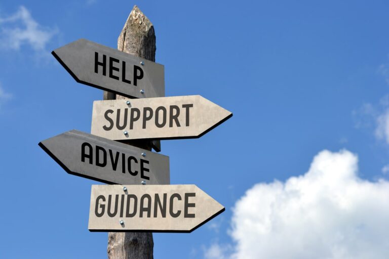 Sign post with arrows that say help, support, advice and guidance pointing in different directions.